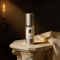 Age Defying Serum on an ivory marble plinth in Baroque candlelight