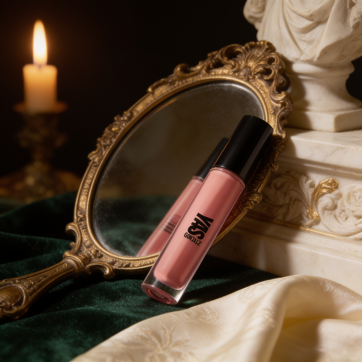 Lip Gloss beside a gilded hand mirror on green velvet