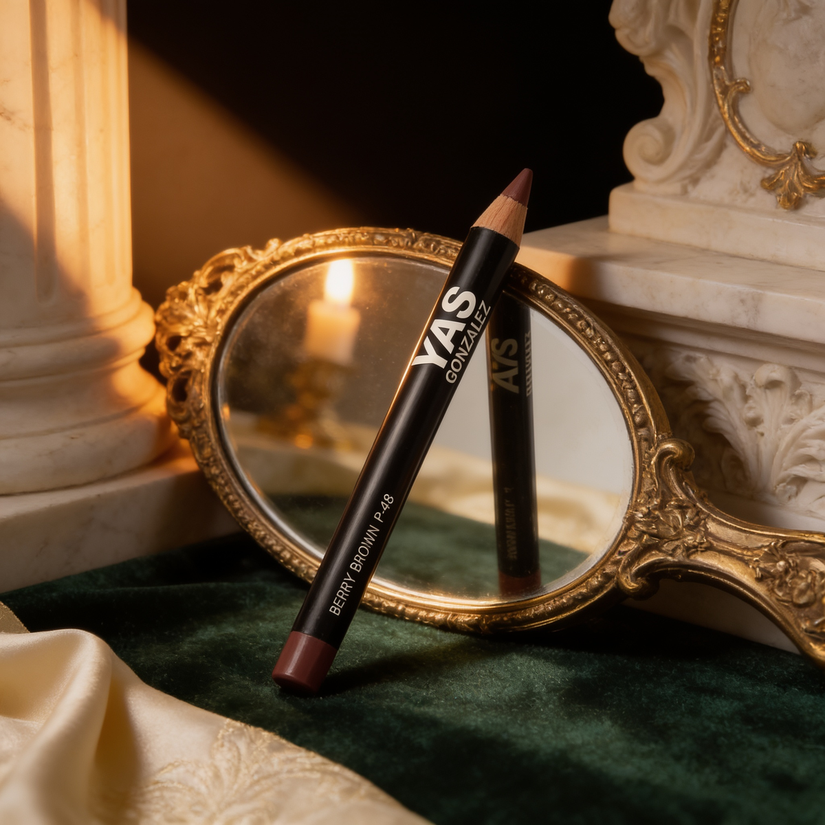 Lip Liner beside a gilded hand mirror on green velvet