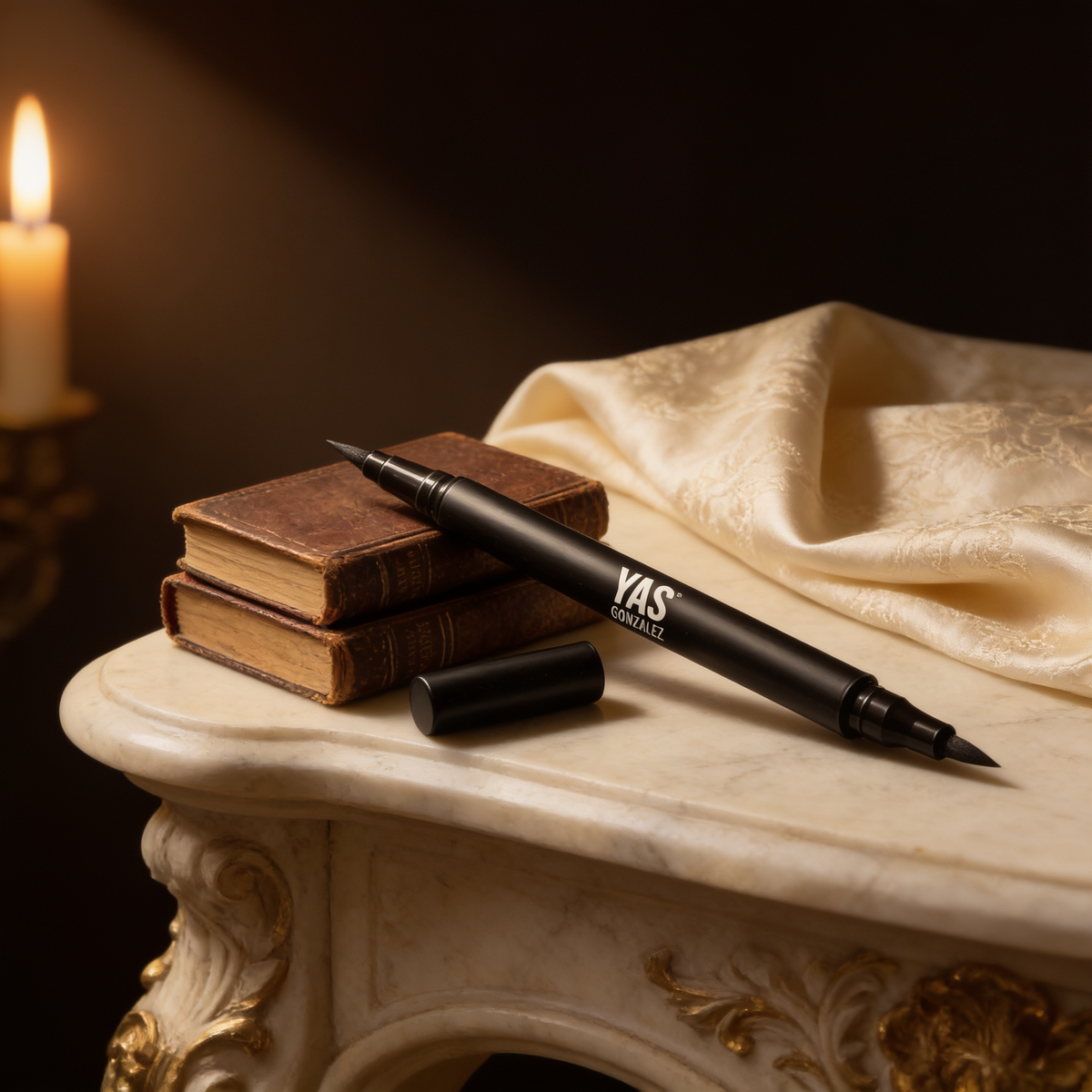 Dual Tip Eye Definer Pen resting on antique leather books